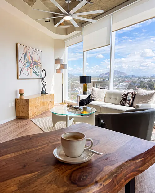 View of Downtown Phoenix outside floor to ceiling windows in a unit kitchen at One Camelback